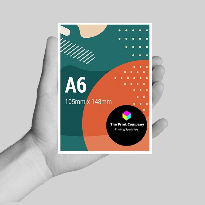 Hand holding a high-quality A6 Leaflet, printed at 105mm x 148mm size with vibrant CMYK colours and abstract geometric design, perfect for event marketing, handouts, or mini-flyers from a professional printing company