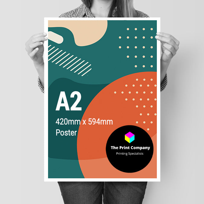 A2 poster held at chest height, measuring 420mm x 594mm, printed with colourful modern graphics and company branding